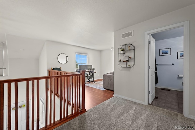 4887 Raven Run, Broomfield, CO 80023 - hallway featuring baseboards, an upstairs landing, and carpet