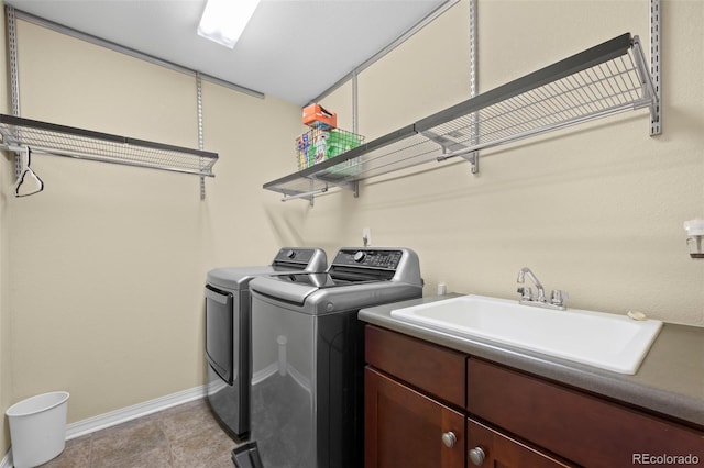 4887 Raven Run, Broomfield, CO 80023 - laundry room with washing machine and dryer, cabinet space, and baseboards