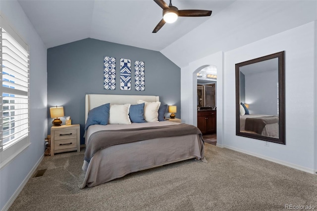 4887 Raven Run, Broomfield, CO 80023 - carpeted bedroom featuring lofted ceiling, multiple windows, a ceiling fan, connected bathroom, and baseboards