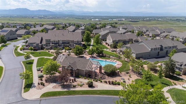 4887 Raven Run, Broomfield, CO 80023 - aerial view of residential area with a pool and mountains