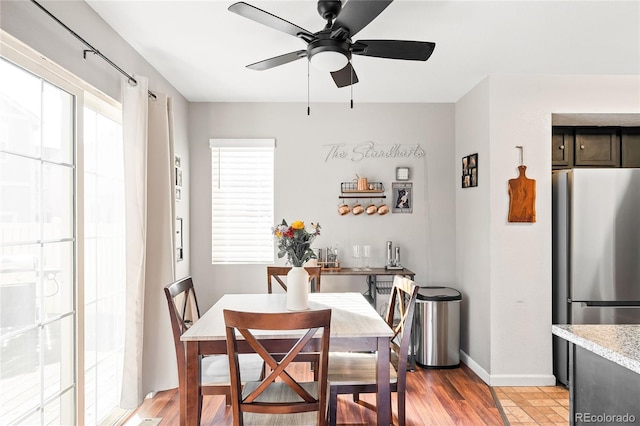 dining room with ceiling fan and light wood-type flooring