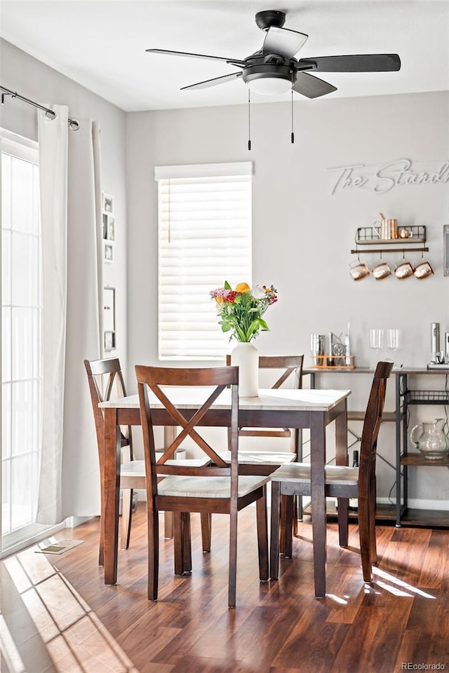 dining area featuring hardwood / wood-style flooring, a healthy amount of sunlight, and ceiling fan