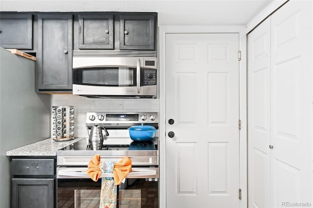 kitchen with stainless steel appliances and backsplash