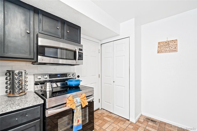 kitchen with decorative backsplash and appliances with stainless steel finishes