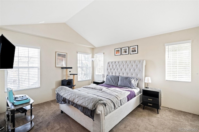 carpeted bedroom with lofted ceiling