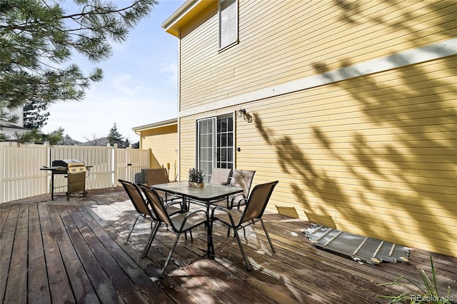 wooden deck featuring a grill