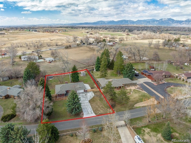 birds eye view of property with a mountain view and a rural view