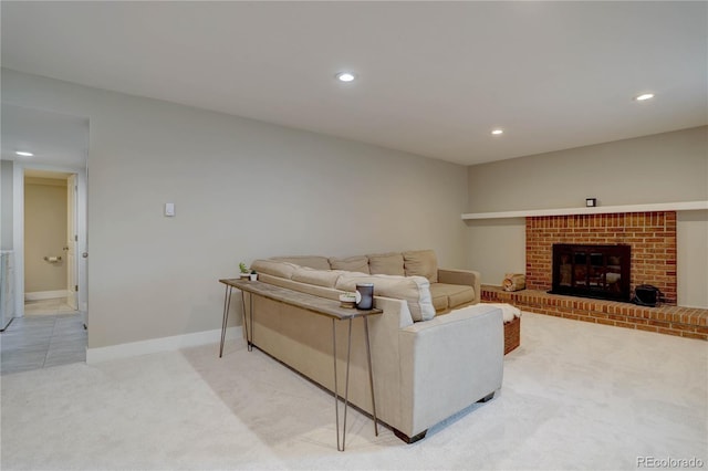 living room featuring recessed lighting, baseboards, light colored carpet, and a fireplace