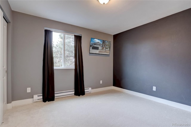 spare room with baseboards and carpet floors