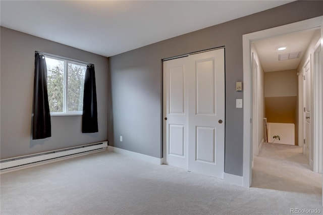 unfurnished bedroom featuring a baseboard radiator, visible vents, a closet, and carpet flooring