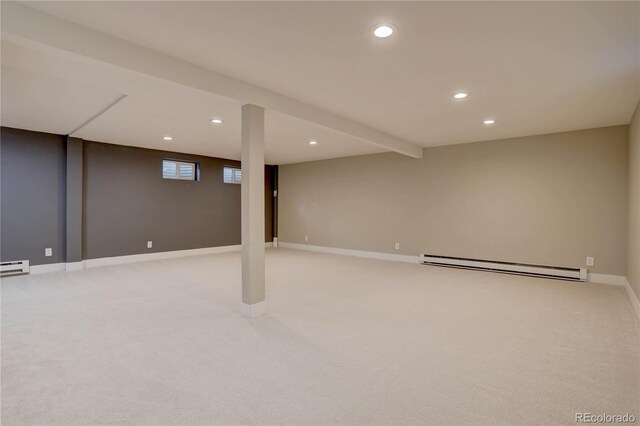 below grade area with recessed lighting, a baseboard radiator, baseboards, and light carpet