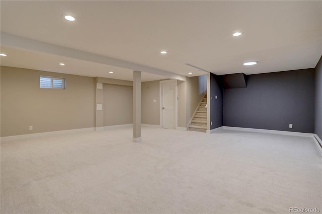 finished below grade area with light carpet, recessed lighting, stairs, and baseboards