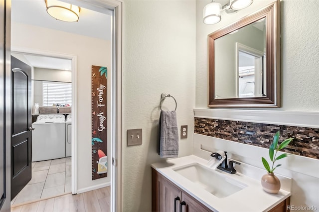 bathroom with washer and dryer and vanity