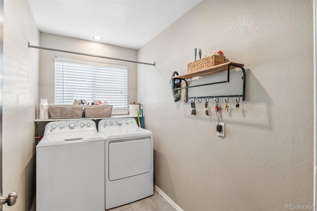 washroom featuring independent washer and dryer and light tile patterned floors