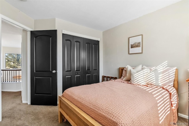 bedroom featuring a closet and light carpet