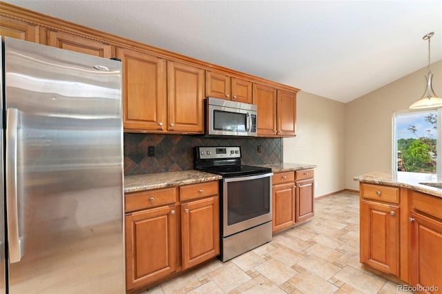 11335 W 54th Ln, Arvada, CO 80002 - kitchen featuring appliances with stainless steel finishes, brown cabinetry, tasteful backsplash, lofted ceiling, and light stone countertops