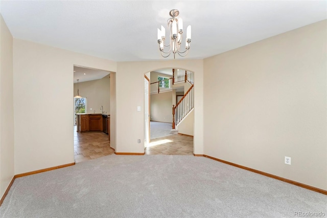 11335 W 54th Ln, Arvada, CO 80002 - unfurnished room featuring plenty of natural light, arched walkways, baseboards, and a chandelier