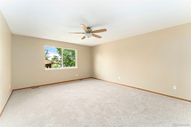 11335 W 54th Ln, Arvada, CO 80002 - spare room featuring ceiling fan, light colored carpet, and baseboards