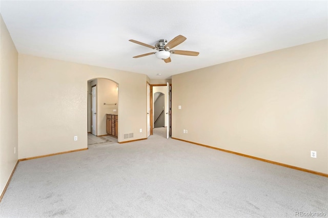 11335 W 54th Ln, Arvada, CO 80002 - empty room featuring arched walkways, ceiling fan, light colored carpet, and baseboards
