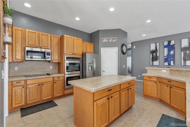 kitchen with appliances with stainless steel finishes, tasteful backsplash, and recessed lighting