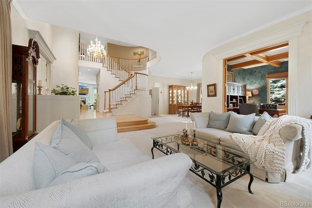 living room with beamed ceiling, light colored carpet, ornamental molding, and a chandelier