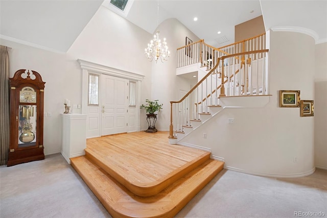 carpeted foyer entrance featuring an inviting chandelier and high vaulted ceiling