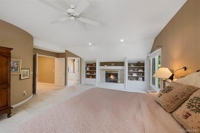 living room featuring built in shelves, ceiling fan, lofted ceiling, and light carpet