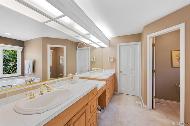 bathroom with vanity, a tub, and toilet