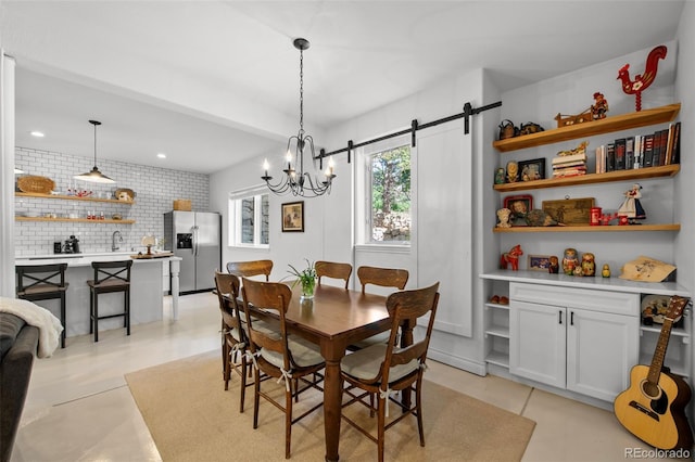 dining area with a barn door and sink