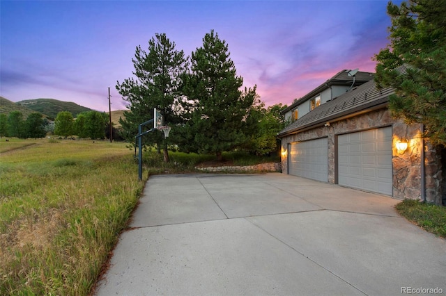 exterior space featuring a garage and a mountain view