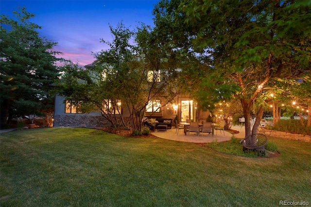 yard at dusk featuring an outdoor hangout area and a patio area