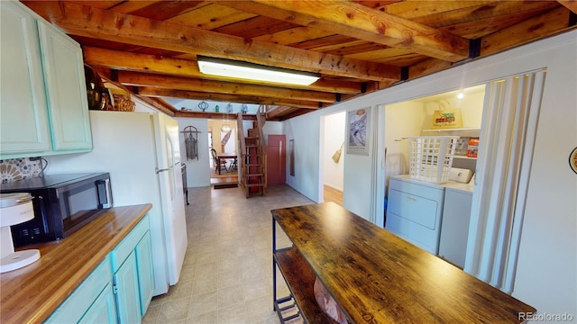 kitchen with wood ceiling, wooden counters, independent washer and dryer, and beamed ceiling