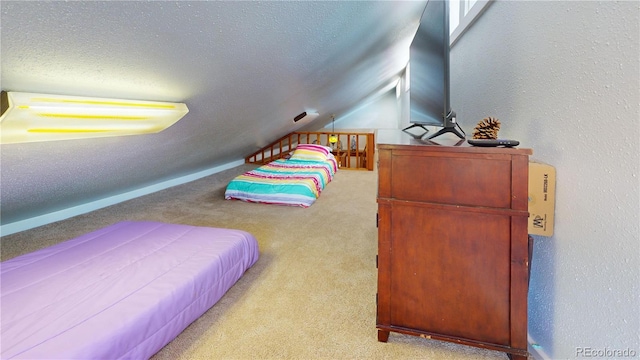 carpeted bedroom featuring a textured ceiling and lofted ceiling