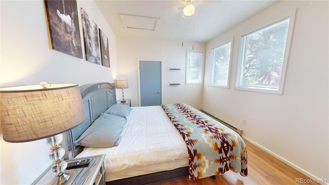 bedroom with ceiling fan and hardwood / wood-style flooring