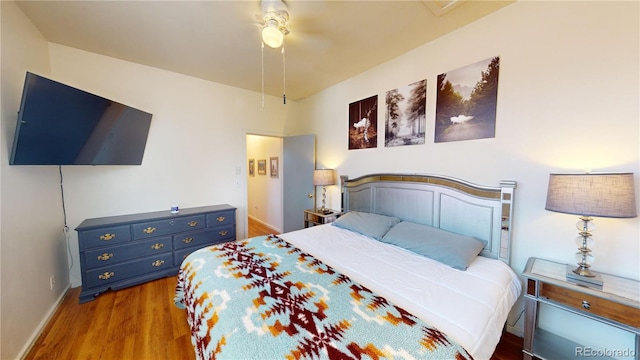 bedroom with ceiling fan and hardwood / wood-style flooring