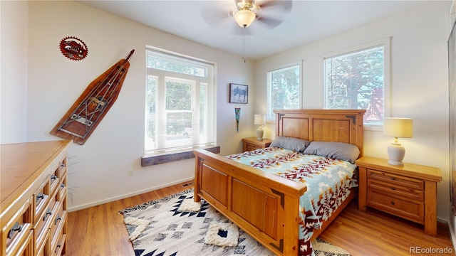 bedroom with ceiling fan and light hardwood / wood-style floors