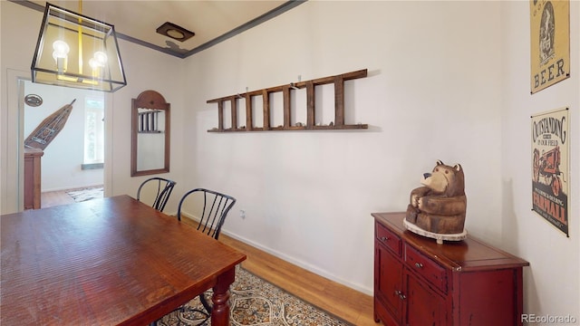 dining area featuring hardwood / wood-style flooring and crown molding