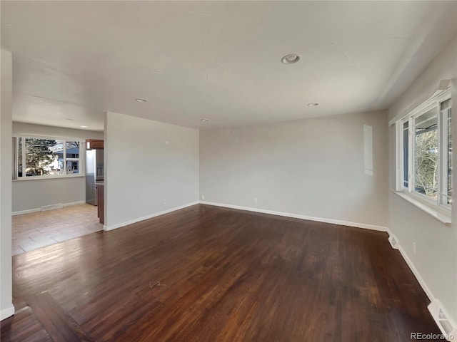 empty room with hardwood / wood-style flooring