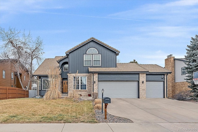 front facade with a garage and a front yard