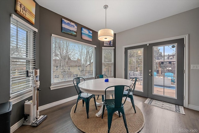 dining room with a healthy amount of sunlight, dark hardwood / wood-style floors, and french doors