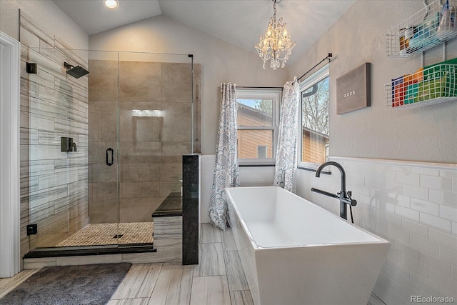 bathroom with vaulted ceiling, tile walls, and plus walk in shower