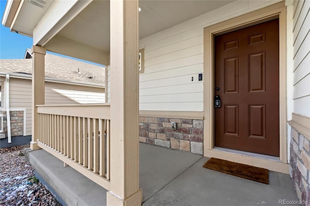 doorway to property featuring covered porch