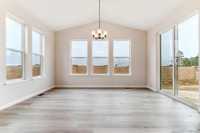 unfurnished dining area with light hardwood / wood-style flooring, a healthy amount of sunlight, and lofted ceiling