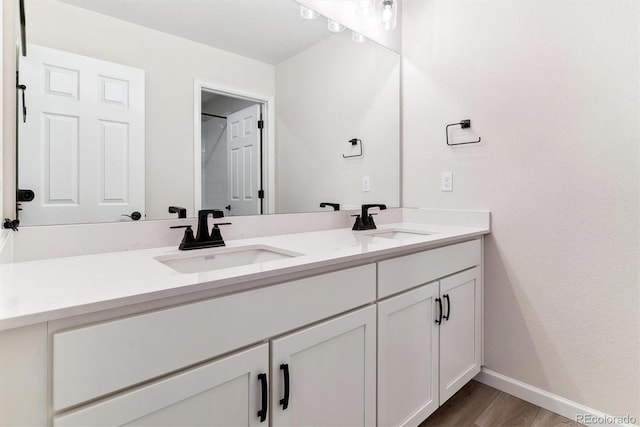 bathroom with hardwood / wood-style floors and vanity