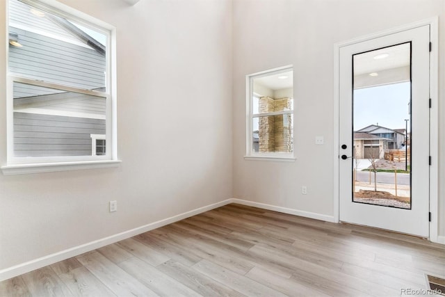 unfurnished room with light hardwood / wood-style floors