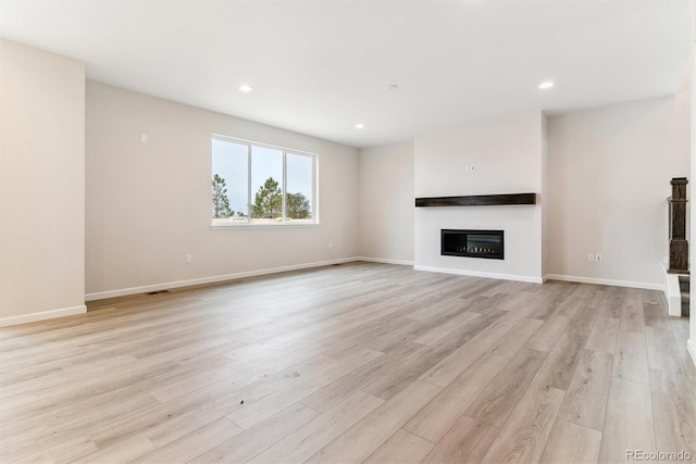 unfurnished living room with light hardwood / wood-style floors