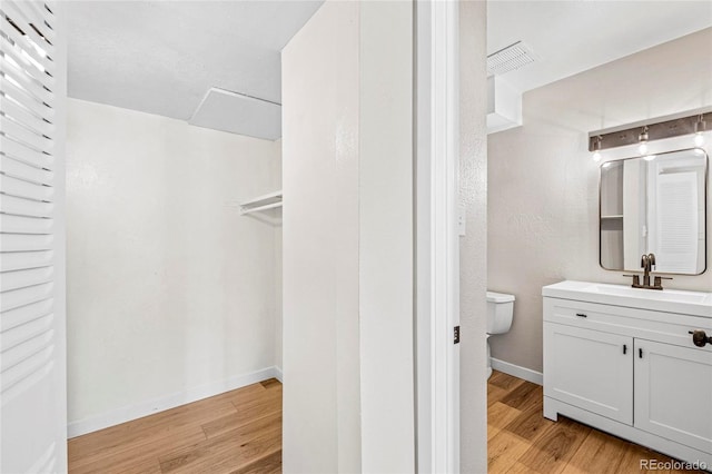 3663 S Sheridan Blvd Unit L6, Denver, CO 80235 - bathroom with wood finished floors and vanity