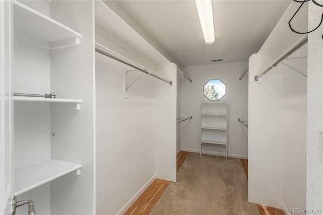 walk in closet featuring wood finished floors and visible vents