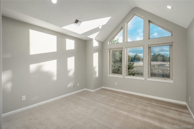 empty room featuring baseboards, visible vents, a skylight, recessed lighting, and light carpet