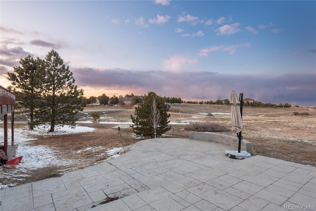 view of patio terrace at dusk